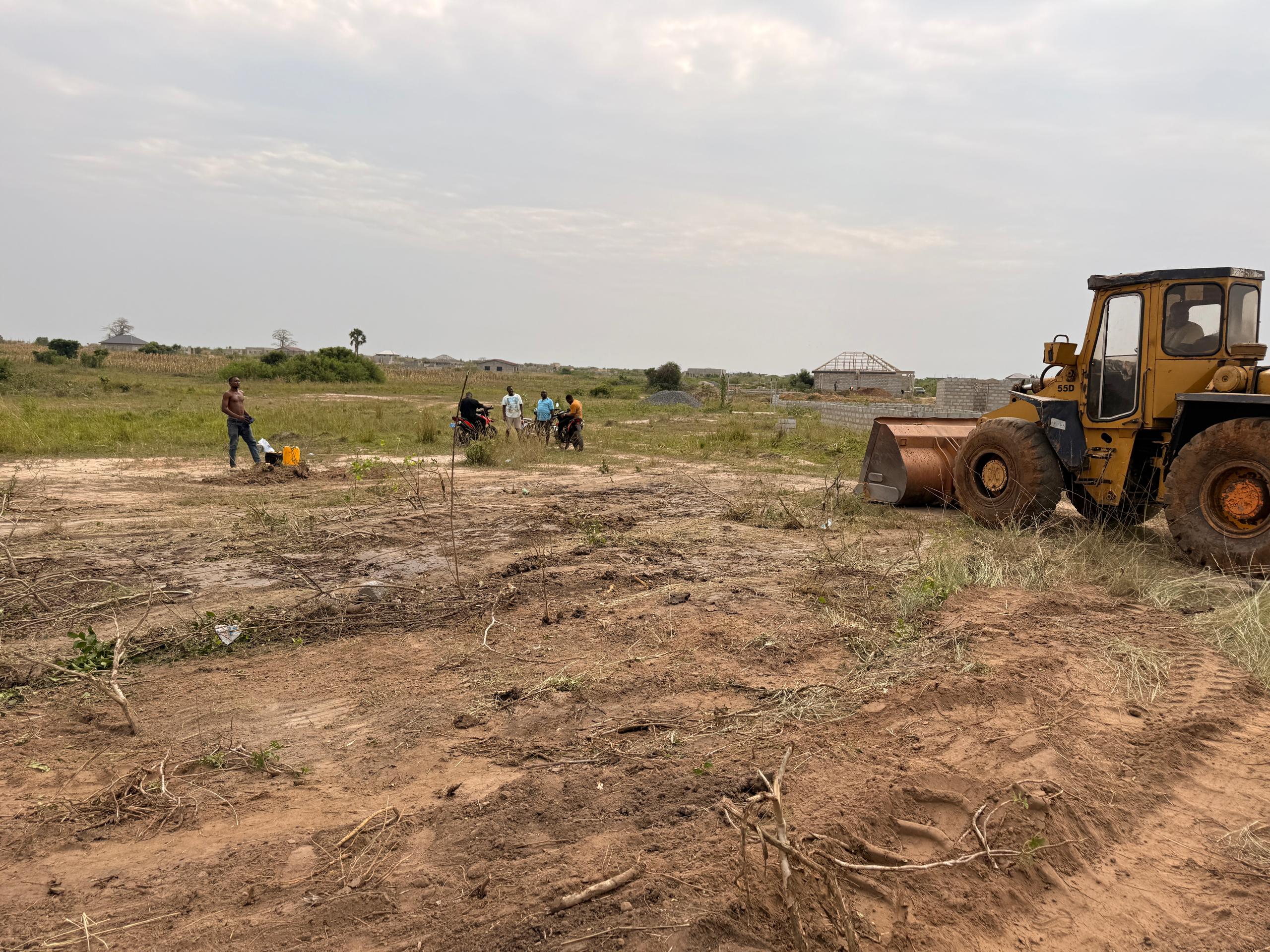 DaveTech surveyors reviewing documents at a boundary pillar on site